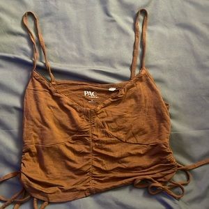 brown tank with a ruffle tie on each side.